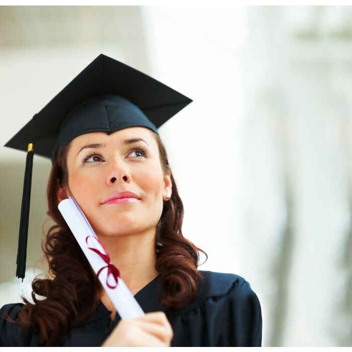 Pretty Young Female Graduate Looking At Copyspace - ID # 12634355