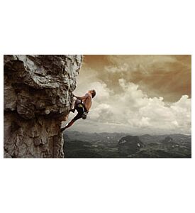 Young man climbing natural rocky wall with tropical valley - ID # 131246312