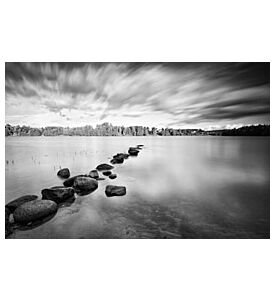 Moving clouds above a tranquil lake in black and white - ID # 38097589