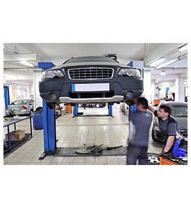 Auto Mechanics Working Under The Car - ID # 23663478